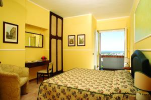 a hotel room with a bed and a television at Hotel Tarconte in Tarquinia