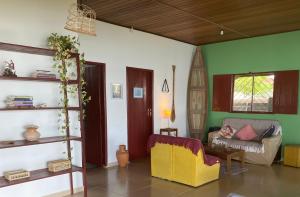 a living room with a couch and a chair at Casa do Rio in Soure