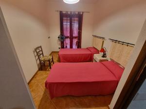 a hotel room with two beds and a window at Casa Vacanze Sa Petra Ruja La Caletta di Siniscola in Siniscola