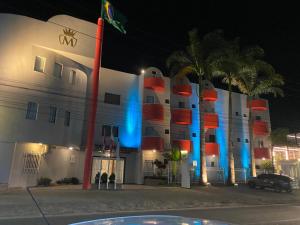 ジェキエーにあるHotel Masterの正面に青と赤のライトがある建物