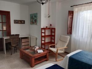 a living room with a bed and a table and a chair at Apartamentos Oreña in Oreña