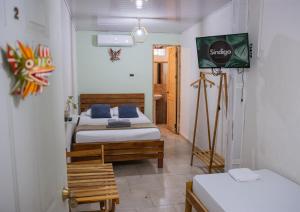 Postel nebo postele na pokoji v ubytování Hostal Síndigo