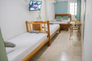 Postel nebo postele na pokoji v ubytování Hostal Síndigo
