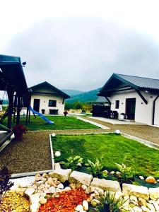 a backyard with a playground with a slide and a house at Domki z Widokiem in Wünschelburg