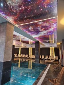 a room with a star ceiling and a swimming pool at Mokoš apartman, Residence hill A35, minimum dve noći in Kopaonik +7 photos