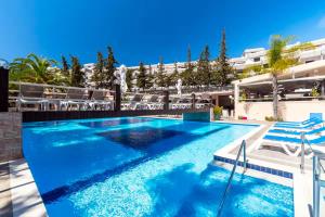 a swimming pool with blue water in a building at Studio on Maria Luisa Beach Wifi Parking Swimming Pool in Olhos de Água