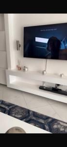a flat screen tv sitting on a white shelf at Luxury villa in Entebbe