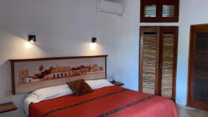 una camera da letto con un letto con una coperta rossa di Mi Casa en Cozumel a Cozumel