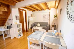 a living room with a table and a couch at The clock house -Centro storico- in Clusone