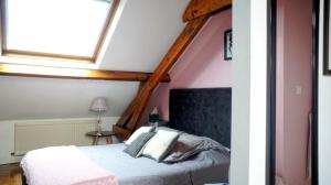 a bedroom with a large bed with a skylight at Malo Les Bains House & Beach Garden 5 min walk in Malo-les-Bains