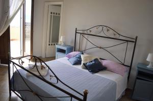 a bedroom with a bed with pillows on it at Domus Agricolae Corallina in Torre del Greco