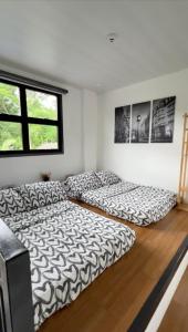 a room with two beds on the floor at The Zentuary - House with pool in Amadeo