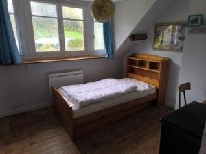 a small bedroom with a bed and a window at Cozy house in Arques-la-Bataille