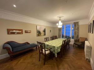 a dining room with a table and chairs at Woodlands in Ventnor