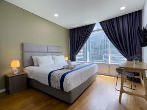 a bedroom with a large bed and a large window at Vortex suites KLCC by Dela in Kuala Lumpur +30 photos