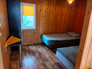 a room with two beds and a window at U Marysii in Śliwin