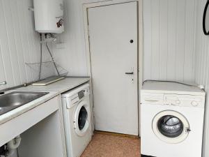 a laundry room with a washing machine and a sink at U Marysii in Śliwin