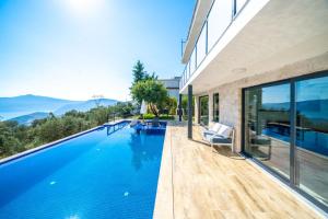 a swimming pool in a house with a view at KaşKalkan Deniz manzaralı Havuzlu Bahçeli Villa in Kas