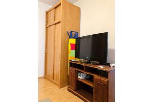 a living room with a television on a wooden table at Apartment Bonaca in Rogoznica