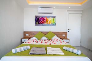 a bedroom with a large bed with two pillows on it at KaşKalkan Deniz manzaralı Havuzlu Bahçeli Villa in Kas +35 photos