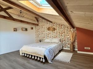 a bedroom with a bed in a room with wooden ceilings at Maison dans les bois in Lacquy