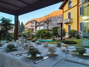 a table with tea cups and saucers on top at Villa Laura in Lierna