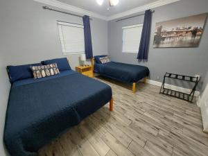 a bedroom with a blue bed and a couch at The Flo's House in Tampa