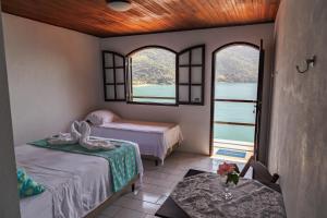 Postel nebo postele na pokoji v ubytování Pousada Toca do Mar