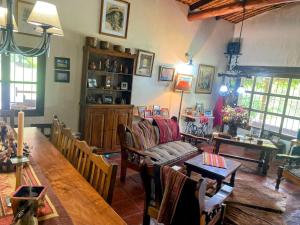 a living room with a table and a couch at Finca los churquis in Tumbaya