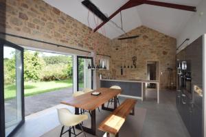 a kitchen and dining room with a wooden table and chairs at Casa La Pedrosa - Tedin in Cee