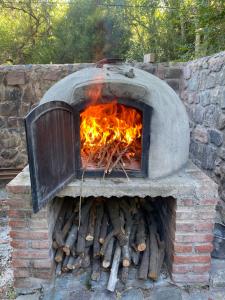 a brick oven with fire inside of it at Finca los churquis in Tumbaya