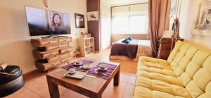 a living room with a couch and a coffee table at Studio on Maria Luisa Beach Wifi Parking Swimming Pool in Olhos de Água