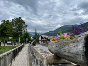 a retaining wall with a bunch of flowers on it at Chalet LE CHEVREUIL Proche La Foux d'Allos in Villars-Colmars