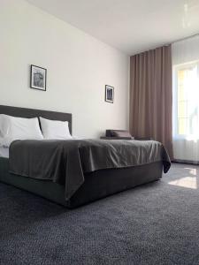 a bedroom with a large bed and a window at Villa Sicilia in Yaremche +13 photos