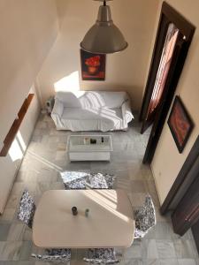 a living room with a couch and a table at Apartamentos Larga 70 in El Puerto de Santa María +108 photos