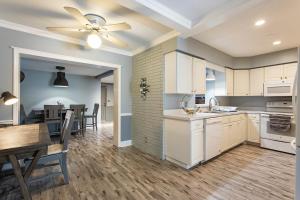a kitchen and dining room with a ceiling fan at The Flo's House in Tampa