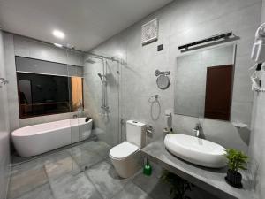 a bathroom with a sink and a tub and a toilet at Blooming Rose Ella in Ella