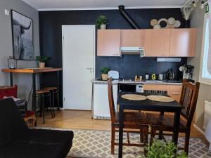 a kitchen with a table and a stove top oven at Studio with sauna near highway in Kempele