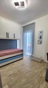 a bedroom with a bed and a large window at Mo' Mo' House in SantʼAntonio Abate