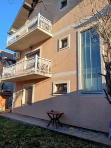 a building with balconies and a table in front of it at SD Apartmani Stan Na Dan in Smederevo