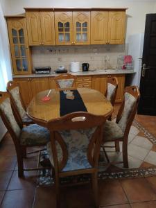 a kitchen with a wooden table and chairs at SD Apartmani Stan Na Dan in Smederevo