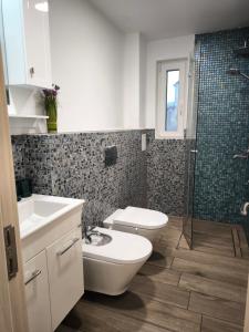 a bathroom with a toilet and a sink and a shower at Victoria Elegance Apartment in Sofia