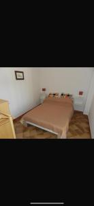 a small bedroom with a bed in a room at Chira House in Santa Marinella