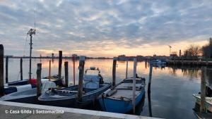 a group of boats docked at a dock in the water at Casa Gilda in Chioggia
