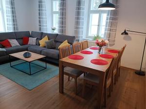 a living room with a table and a couch at Apartmány Karina in Janske Lazne