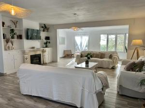 a living room with white furniture and a fireplace at BINIFORCAT in Cala en Forcat