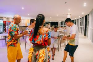 a group of people standing around in a room at Costeira Palace Beach Resort All Inclusive in Natal +83 photos
