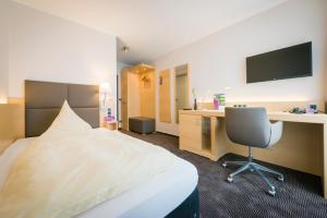 TV a/nebo společenská místnost v ubytování Hotel Lücke Rheine