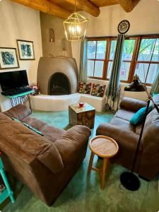 a living room with a couch and a fireplace at Cozy & Relaxing Near Taos Plaza in Taos