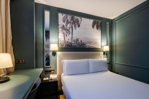 a bedroom with a white bed and two windows at BYPILLOW Castellana in Madrid +35 photos